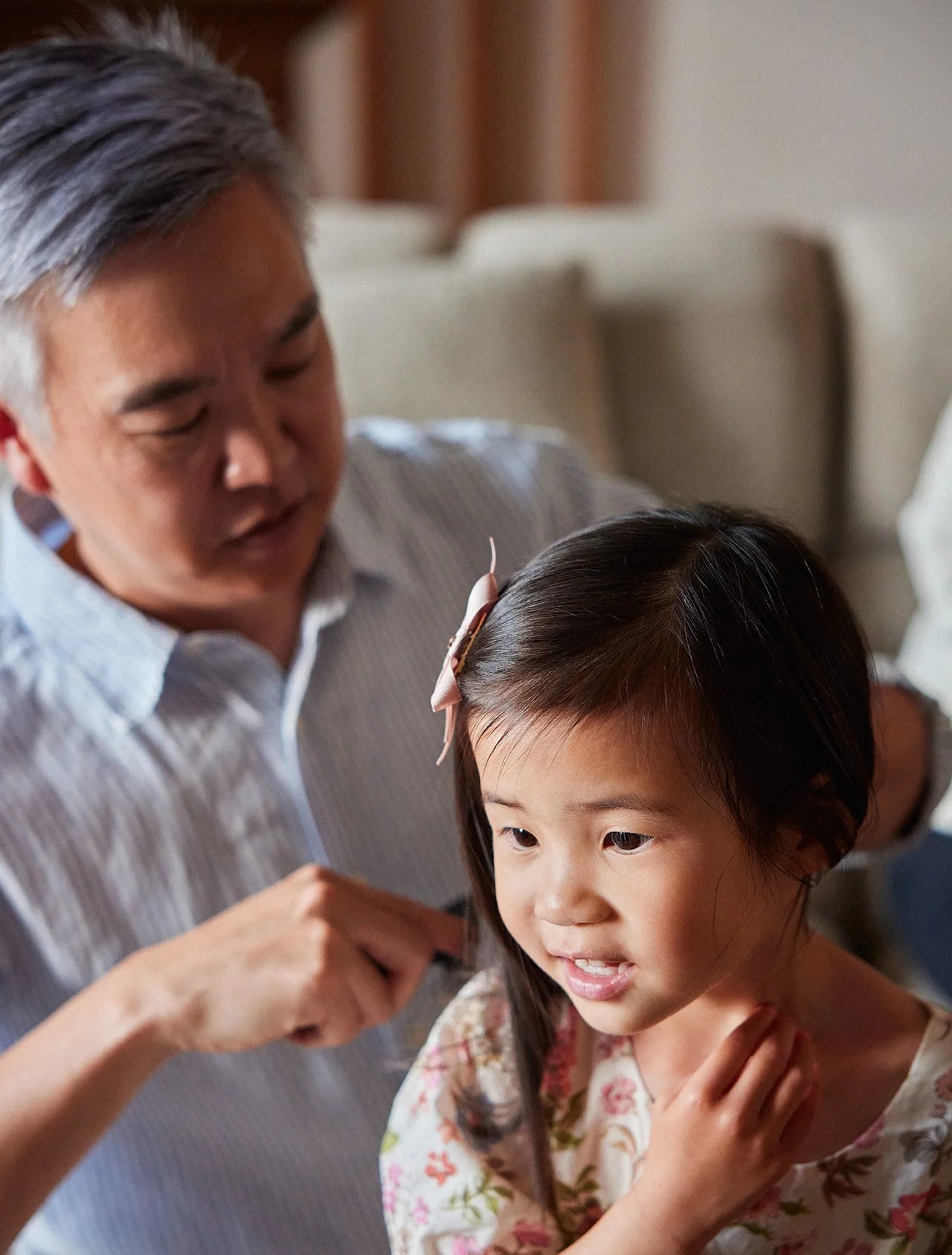 A father brushing his daughter’s hair after bath time